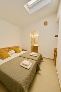 a bedroom with two beds with towels on them at VILLA MAR in Cala'n Bosch