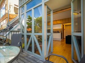 a room with glass doors and a glass table at Laimes kopa Pervalka in Pervalka