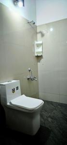 a bathroom with a white toilet in a room at Goodkarma Inn in Cochin +23 photos