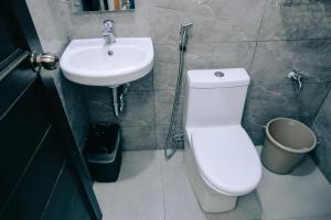 a bathroom with a white toilet and a sink at RedDoorz near Mariners Legazpi in Legazpi