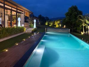 une piscine devant une maison la nuit dans l'établissement Villa VH 4 Bedroom villa with heated swimming pool, à Kigali