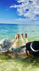 zwei Menschen, die im Meer liegen in der Unterkunft Seascapes And Beaches in Falcon