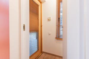 a hallway with a door and a window at Gauja forest retreat in Gauja