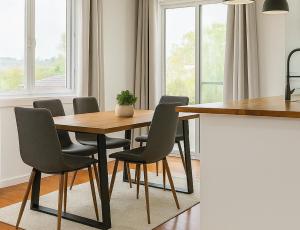 a dining room with a table and chairs at Patricks Road Ferny Hills in Ferny Hills