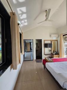 a bedroom with a bed and a view of a room at Cloud Green Resort in Mahabaleshwar +55 photos