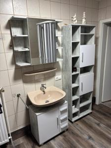 a bathroom with a sink and a mirror at FeWo Papenburg im OG - Nähe City in Papenburg