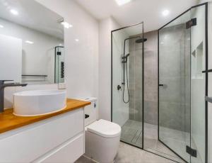 a bathroom with a shower and a toilet and a sink at Patricks Road Ferny Hills in Ferny Hills +2 photos