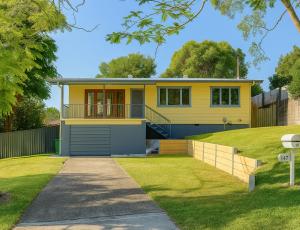 a yellow house with a driveway in front of it at Patricks Road Ferny Hills in Ferny Hills
