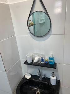 a bathroom with a black sink and a mirror at Apartamento 03 São Brás COP30 in Belém +5 photos