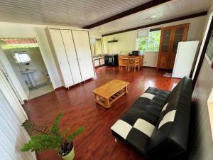 a living room with a couch and a table at Ataani Lodge in Hiva Oa