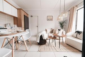 a living room with a couch and a table at Casa de Lior!- Luxury apartment in Sandton