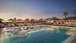a swimming pool with lounge chairs and a resort at InterContinental Hotels Table Bay Cape Town by IHG in Cape Town