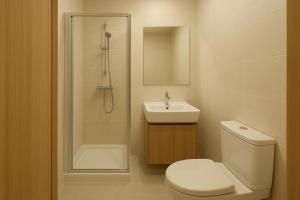 a bathroom with a toilet and a sink and a shower at Busan Seomyeon Nestly Hotel in Busan