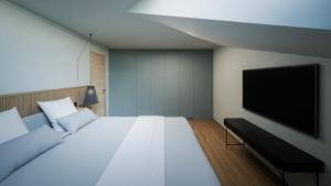 a bedroom with a large bed and a flat screen tv at Hotel Rosatsch in Pontresina +178 photos