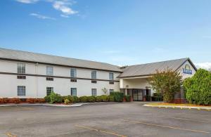 a large white building with a parking lot at Days Inn by Wyndham Lincoln in Lincoln