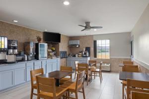 a kitchen and dining room with a table and chairs at Days Inn by Wyndham Lincoln in Lincoln