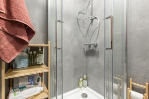 a shower with a glass door in a bathroom at Gauja forest retreat in Gauja +9 photos