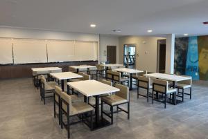 a classroom with tables and chairs and a chalkboard at Wingate by Wyndham Geneva at SPIRE Academy in Geneva