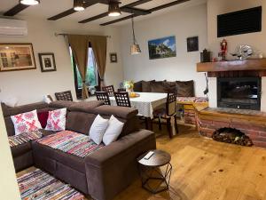 a living room with a couch and a table at Holiday Home Kalnik in Kalnik