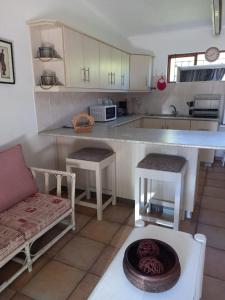 a kitchen with a couch and a counter top at The Palm Tree in Saldanha