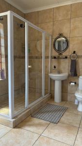 a bathroom with a shower and a sink at The Palm Tree in Saldanha