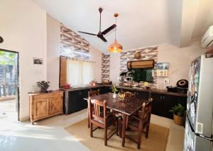 a kitchen with a table and a dining room at The Plix Villa, Vagator in Anjuna