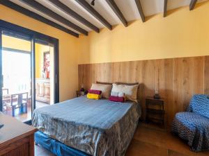 a bedroom with a bed and a chair at Villa Jenuska, Attractive holiday home in Callian with private pool in Callian