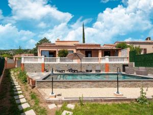 a villa with a swimming pool in front of a house at Villa Jenuska, Attractive holiday home in Callian with private pool in Callian +61 photos