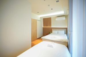 Giường trong phòng chung tại 中野ワールドホテル