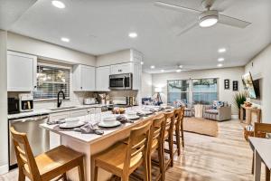 a large kitchen with a long table and chairs at Lantana - 5251A in Siesta Key