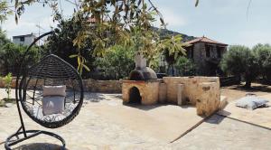a sculpture of a chair in front of a fountain at Wunderschönes Ferienhaus In Agios Stefanos in Foútia +32 photos