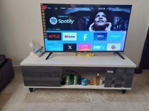 a tv on top of a tv stand at Shared Studio in a marvel location and marvel furniture in Abu Dhabi Center in Abu Dhabi