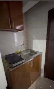 a kitchen with a sink and a counter top at Shared Studio in a marvel location and marvel furniture in Abu Dhabi Center in Abu Dhabi +5 photos