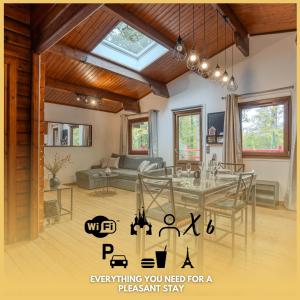 a living room with a table and a couch at Le chalet forestier de Guerlande - Disney 20min in Pézarches