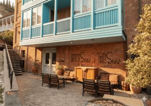 a building with chairs and a table in front of it at TbiliSee Hotel in Tbilisi City