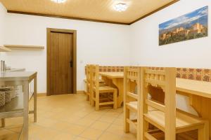 a kitchen with a wooden table and chairs at Hostal Yeti in Sierra Nevada +26 photos