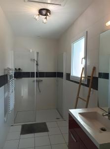 een badkamer met een glazen douche en een wastafel bij L'Estran qu'Île - Proche plages in LʼÎle-dʼOlonne