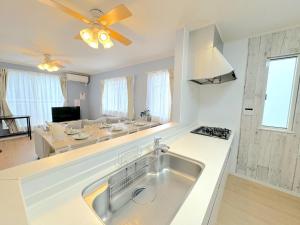 a kitchen with a sink and a living room at THE FEEL ONNA 2 / Vacation STAY 18776 in Onna