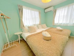 a bedroom with a large bed with two baskets on it at THE FEEL ONNA 2 / Vacation STAY 18776 in Onna