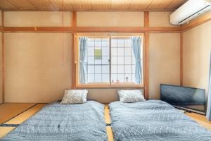 Ένα ή περισσότερα κρεβάτια σε δωμάτιο στο Kugenuma Kaigan Beachside House#ENOSHIMA#Aquarium