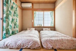 Ένα ή περισσότερα κρεβάτια σε δωμάτιο στο Kugenuma Kaigan Beachside House#ENOSHIMA#Aquarium