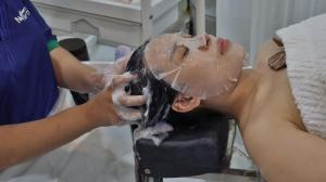 a woman getting her hair washed in a sink at NV Sport Camping & Hotel - Ho Tram in Xuyên Mộc