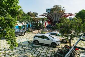 two cars are parked in a parking lot at NV Sport Camping & Hotel - Ho Tram in Xuyên Mộc