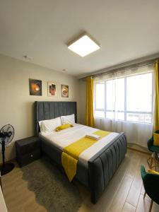 Postel nebo postele na pokoji v ubytování Studio Indesign Makumbi Park, Syokimau with Pool near JKIA & SGR