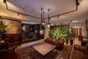 a lobby with a table and chairs and a bar at TbiliSee Hotel in Tbilisi City