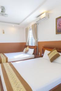 Ένα ή περισσότερα κρεβάτια σε δωμάτιο στο Hưng Phát Hotel Tân Phú