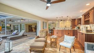 a kitchen and living room with a ceiling fan at Gulf Birdie - 5551 in Siesta Key