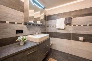 a bathroom with a sink and a mirror at Alpenappart in Cadipietra +59 photos