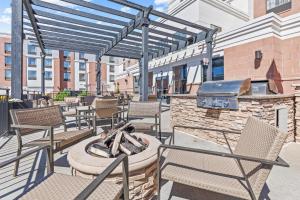 an outdoor patio with chairs and a grill at Homewood Suites by Hilton Denver Tech Center in Englewood