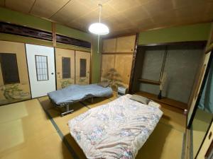 a hospital room with two beds and a window at 九州 福岡 貸切 プライベートハウス 